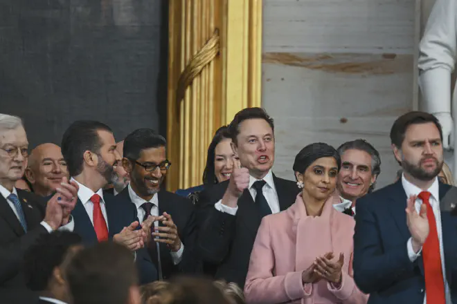 Jeff Bezos, from second left, Donald Trump Jr., Sundar Pichai, Elon Musk, Usha Vance, Doug Burgum and Vice President JD Vance applaud during the 60th Presidential inauguration in the Rotunda of the U.S. Capitol in Washington, Monday, Jan. 20, 2025. (Kenny Holston/The New York Times via AP, Pool)